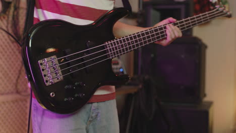 Close-Up-Of-An-Unrecognizable-Man-Playing-Electric-Guitar-And-Pressing-Effects-Pedal