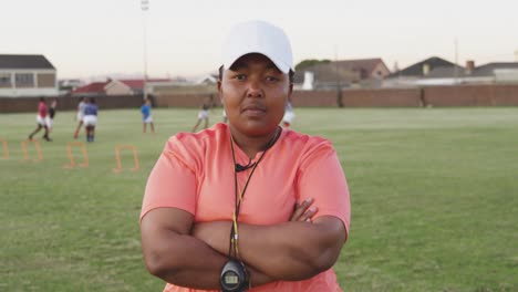 portrait of female rugby coach on a rugby pitch
