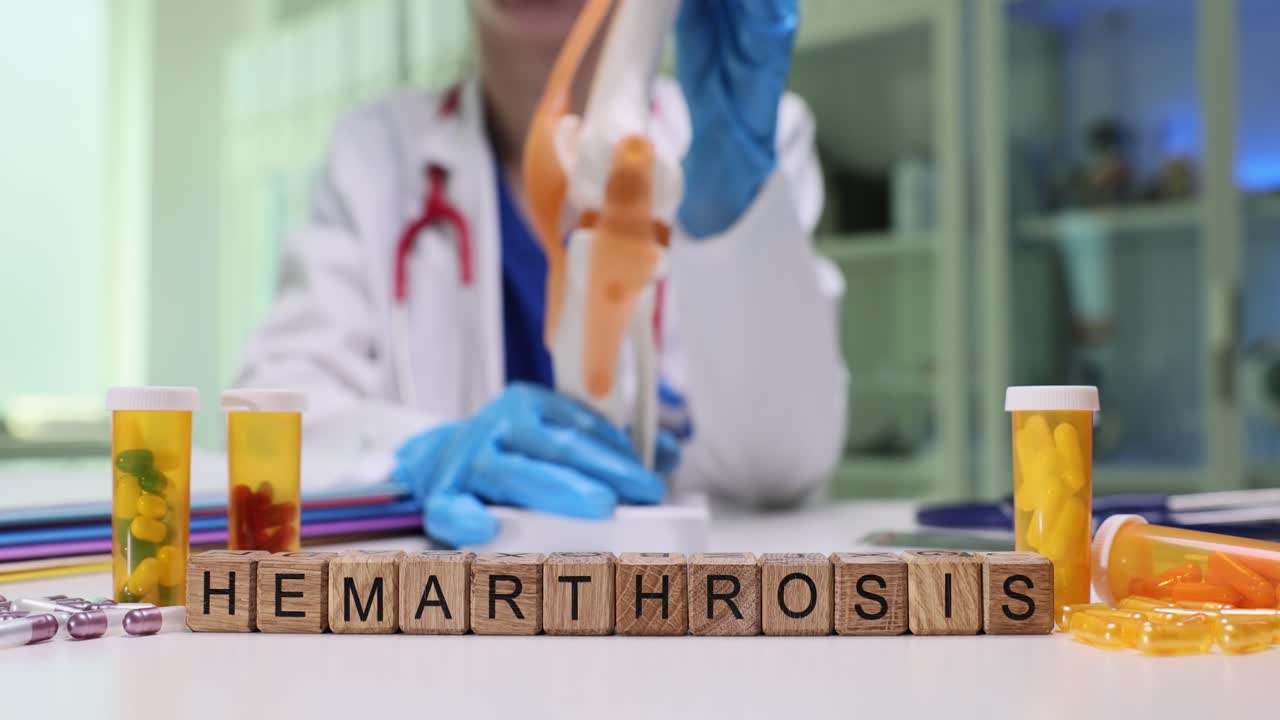 Medical professional with knee model and pills, spelling "Hemarthrosis" with blocks
