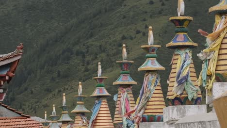 Colorful-Buddhist-sculptures-against-green-hill-in-Bamei