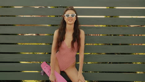 woman in swimsuit with skateboard