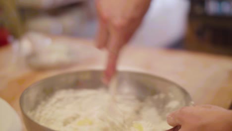 bakery mixing ingredients in bowl