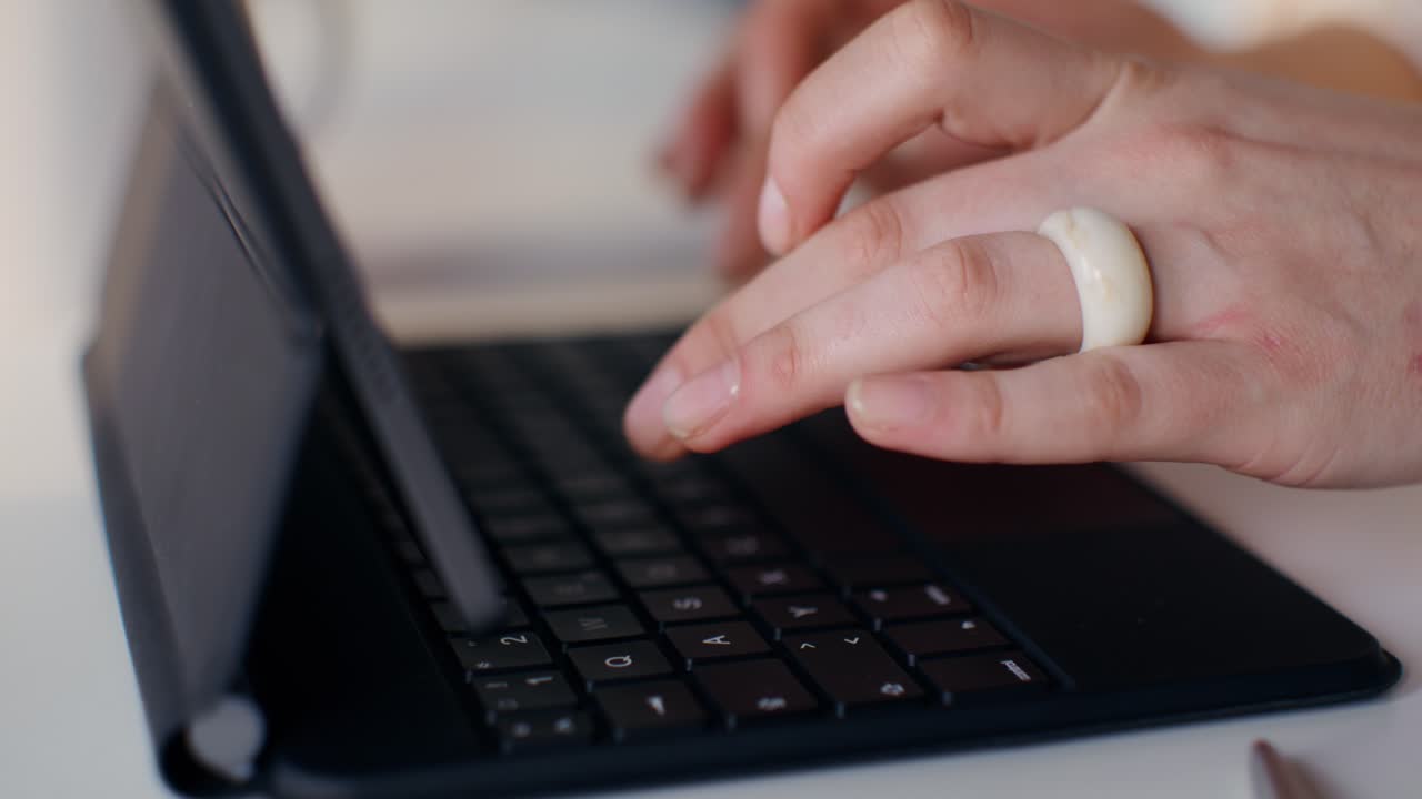Woman Typing on a Tablet Keyboard