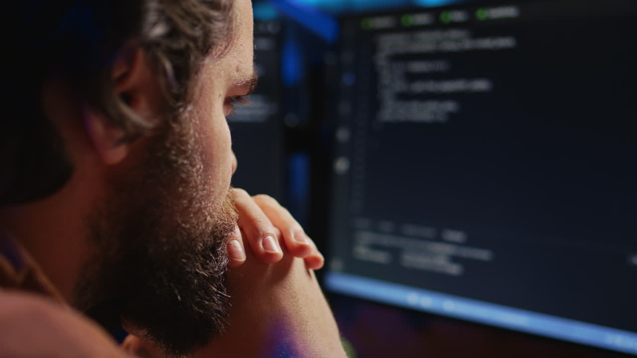 IT admin frowning while looking at screen, confused by errors, close up shot
