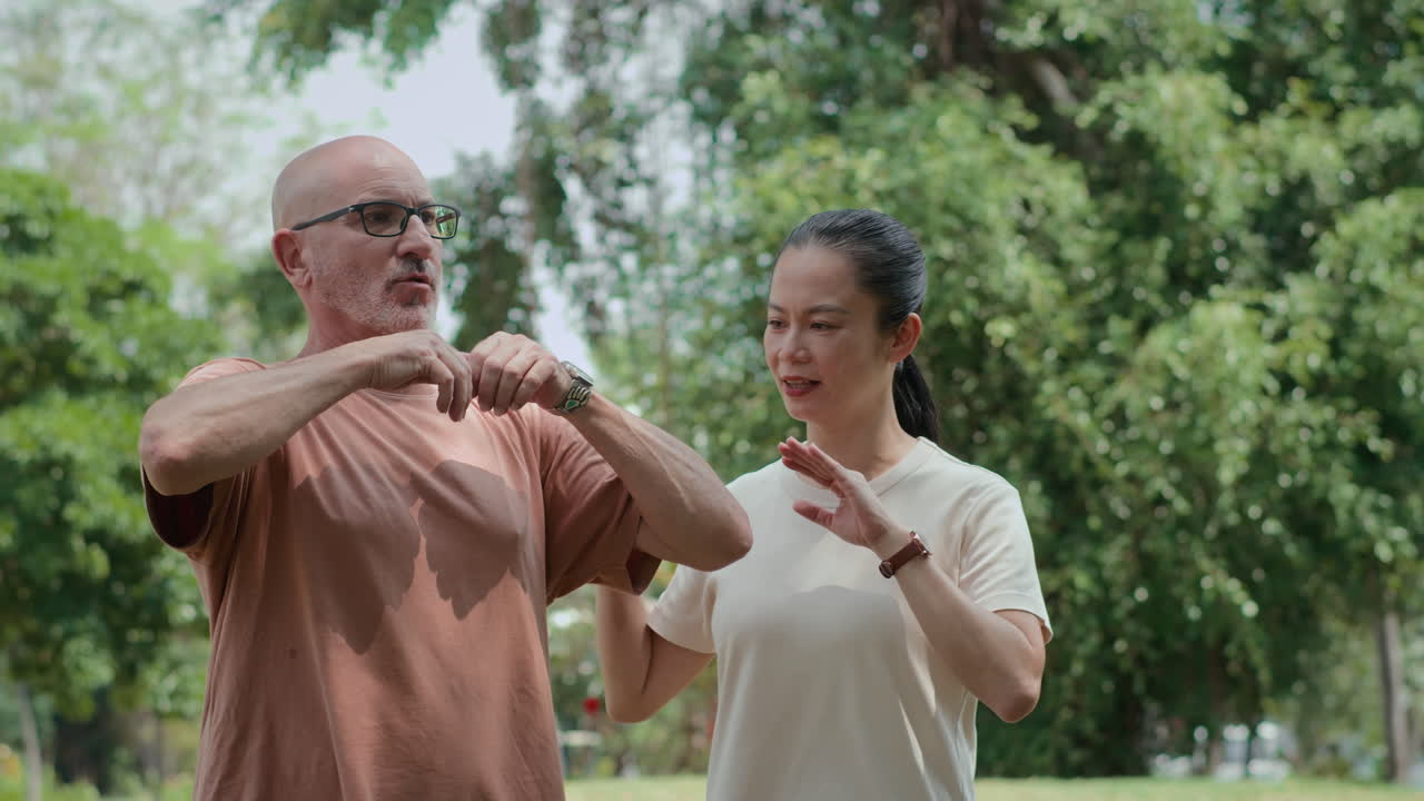 Trainer Helping Male Client Exercising Tai Chi