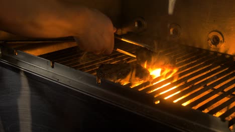 cheff grills meat, with flames