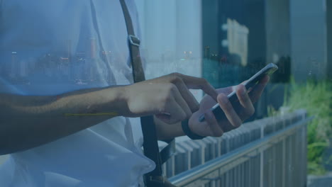 animation of man using smartphone over cityscape