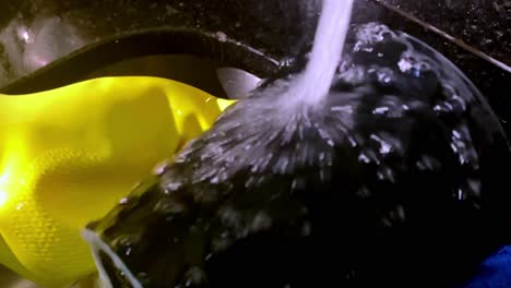 household chores, washing dishes, hot water flowing, latex gloves, slow-mo