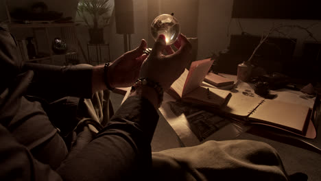 man holding a globe in a study