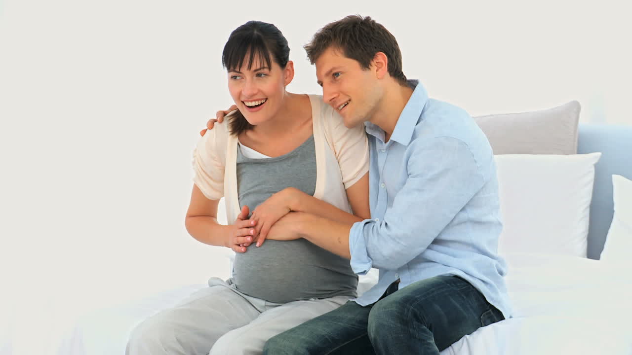 Couple feeling movements of their future baby 