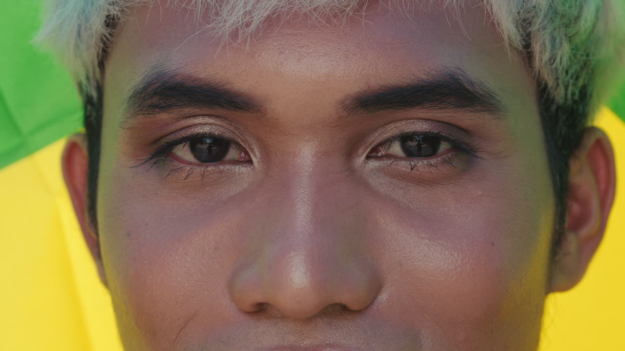 Close-up portrait of a person with makeup and colorful background