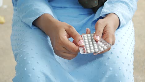 Women-hand-golding-birth-control-pills-close-up