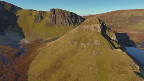 cliffs and isolated peak of landslip in early morning winter sunshine