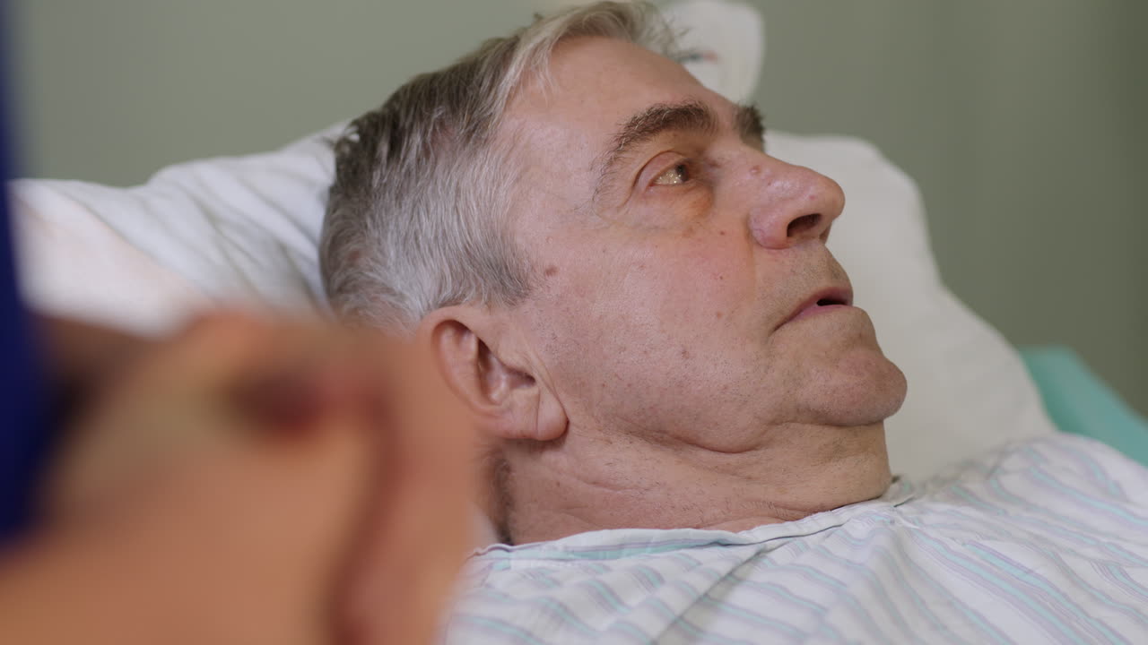 Elderly man resting in hospital bed