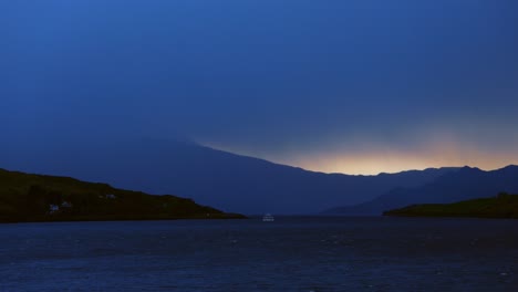 Dramatic Twilight over a Scottish Loch with Distant Boat