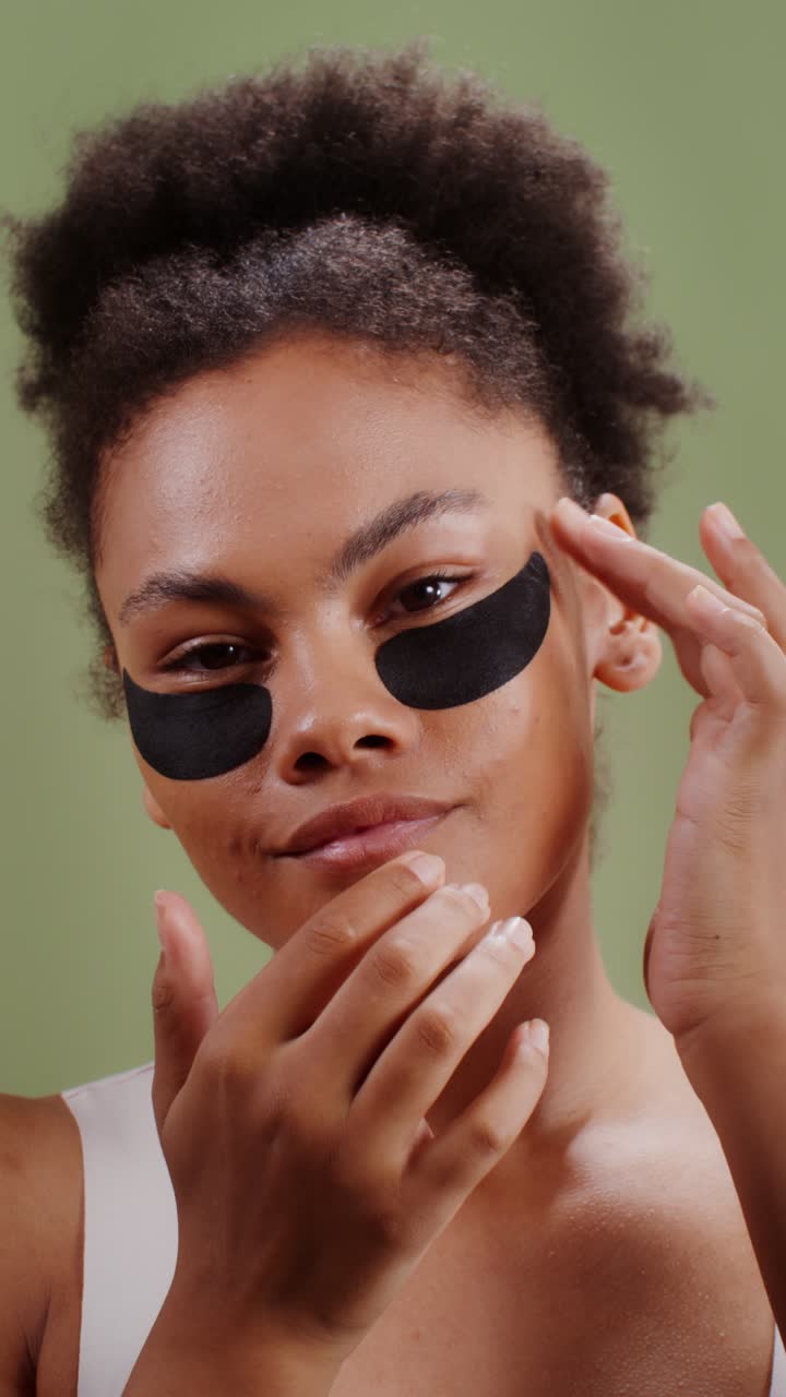 Woman applying eye patches