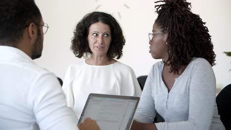 excited woman talking to colleagues during meeting