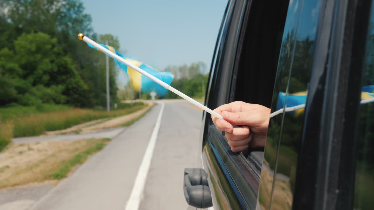 자동차 창 여행 스칸디나비아 개념에 스웨덴 국기와 손