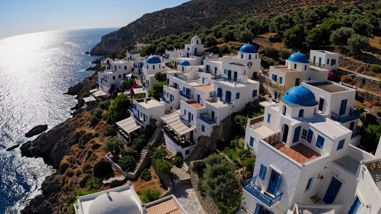 Aerial video view of white and blue coastal village, showcasing Mediterranean architecture