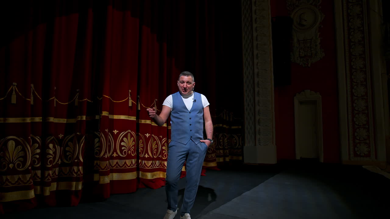 Actor performs on stage. Man on stage during performance in theater