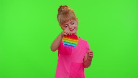 Child-girl-kid-playing-squeezing-anti-stress-pop-it-touch-screen-toys-simple-dimple-game,-chroma-key