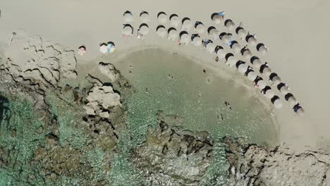 Aerial-drone-shot-of-perfect-beach-with-umbrellas