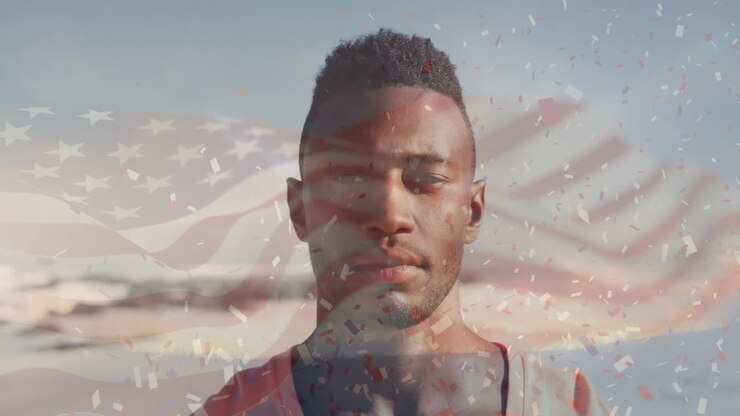 Animation of flag of united states of america and confetti over african american man on beach