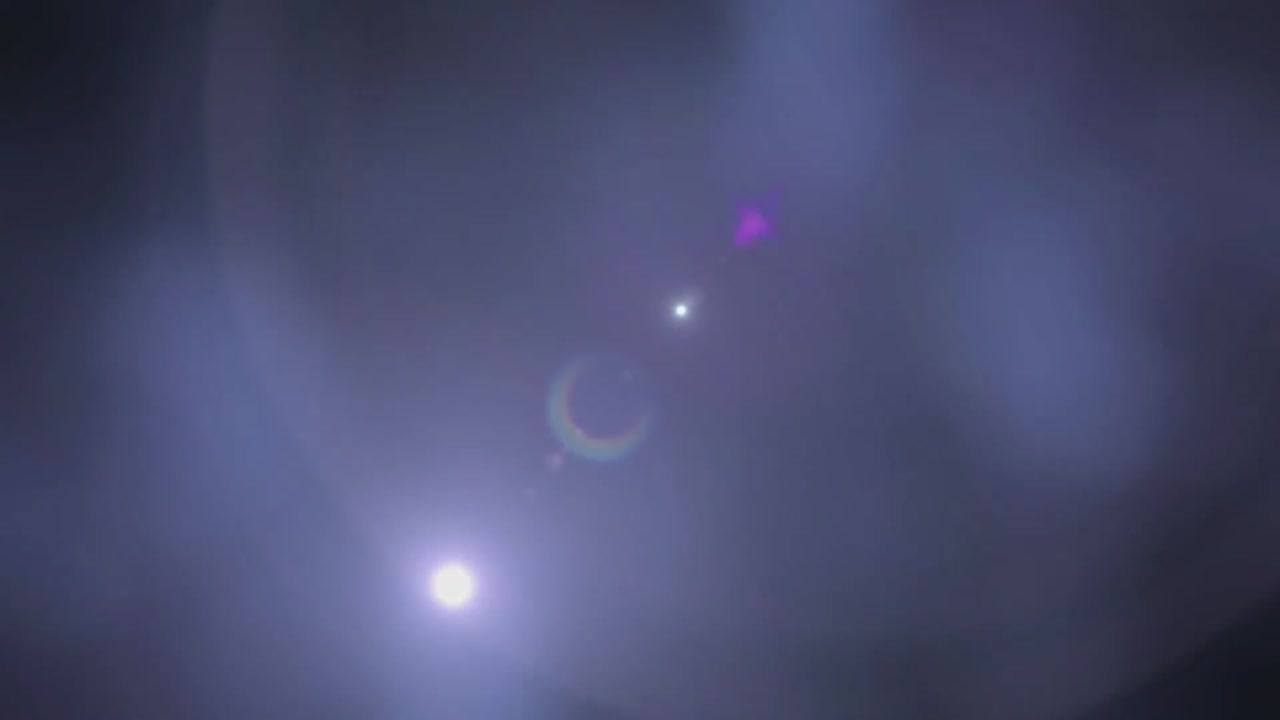 Animation of light moving around on dark blue background