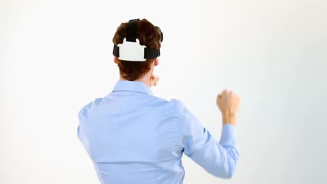 Man-gesturing-while-using-virtual-reality-headset-against-white-background-4k