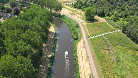 aerial drone shot above a nature park, water canal with boats, of almere city, province flevoland, netherlands