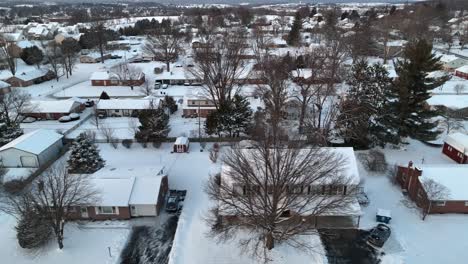 american neighborhood covered in snow on cold winter evening