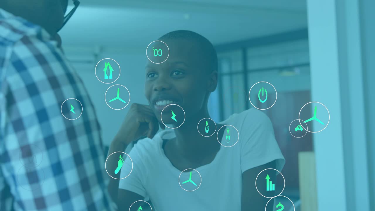 Man speaking engaging woman in office causing finance and energy icons multiplying around her