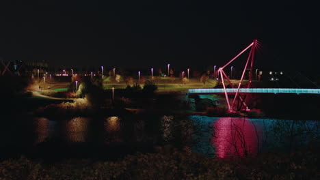 pae park pedestrian bridge night view illuminated with light over the lake, tallinn, estonia