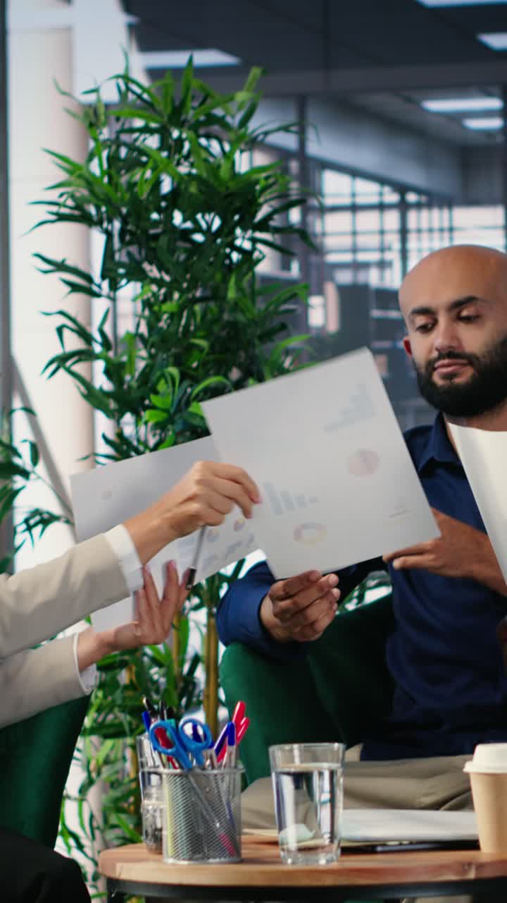 Vertical Video Diverse business professionals using analysis tools to extract insights