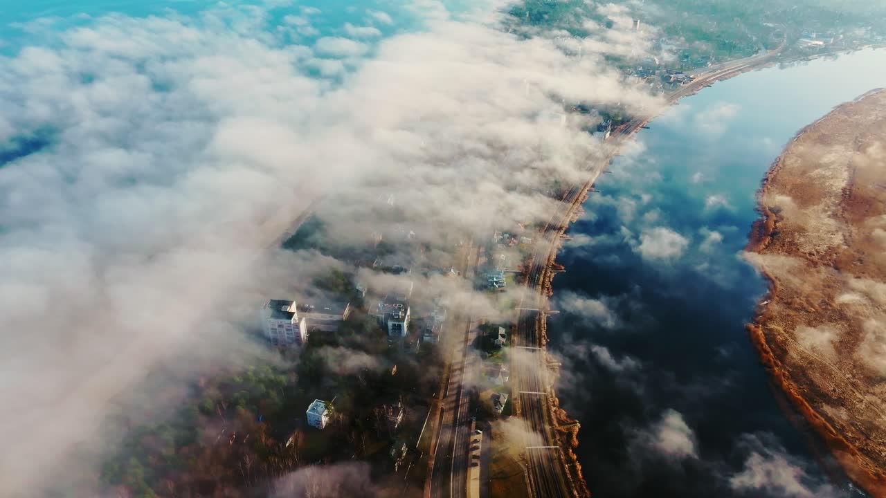 Lielupe river curves through Jūrmala under dense fog, bright sea reflections