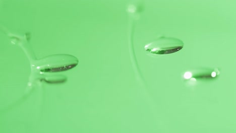 micro video close up of water drops with copy space on green background