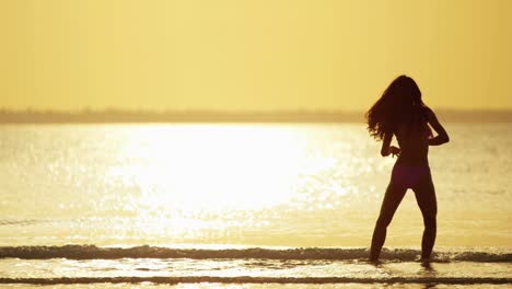 ethnic female in swimwear on tropical ocean beach