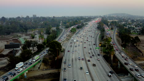 aerial view of multi-lane highway with heavy traffic at dusk