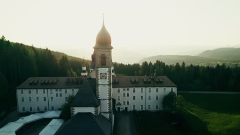 aerial view of a monastery in the italian alps at sunrise/sunset