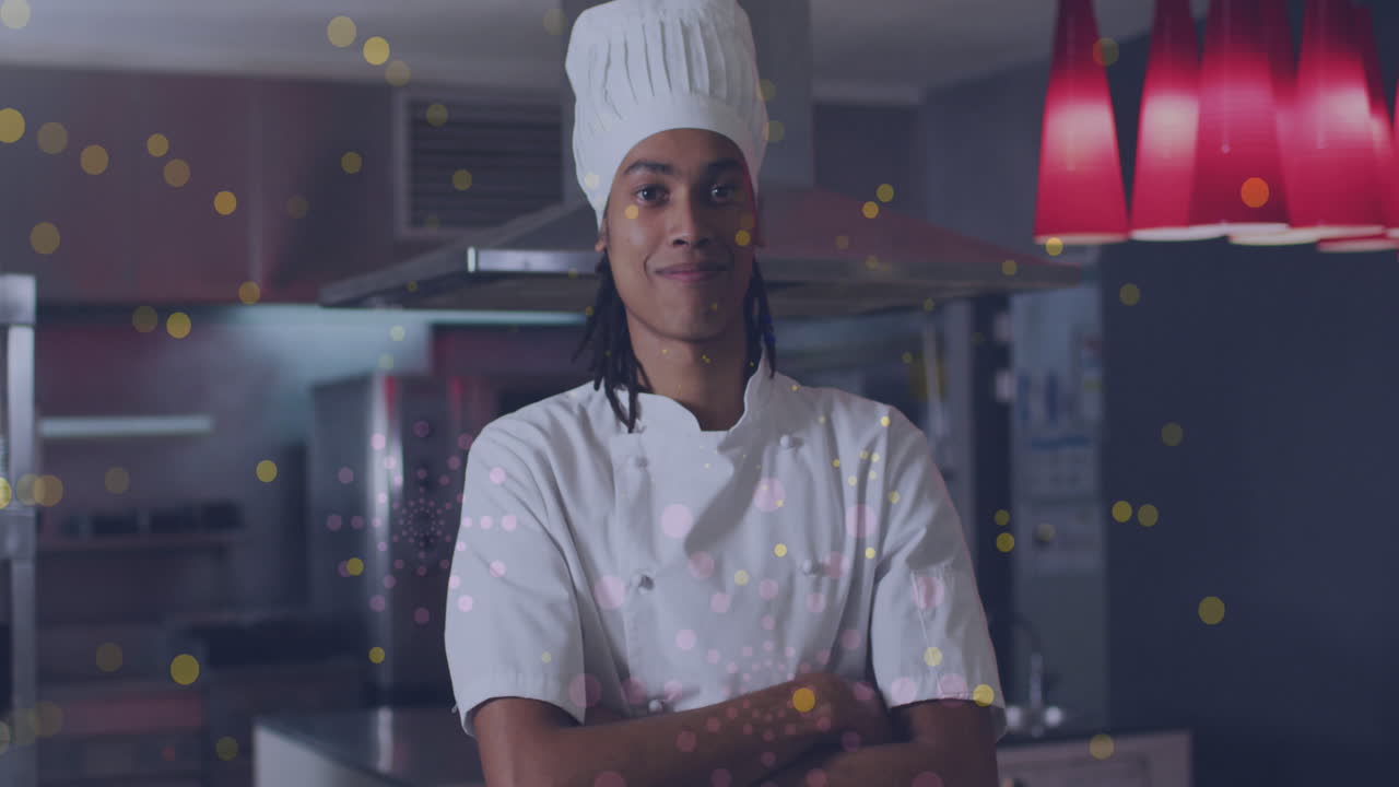 animación de puntos sobre un feliz chef masculino biracial con los brazos cruzados