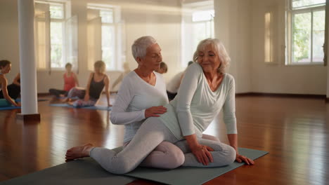 senior women practicing yoga in a studio