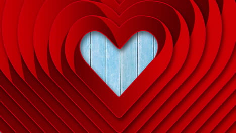 layered red heart shapes animating over blue wooden background