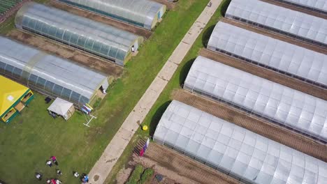 aerial view of a large greenhouse complex with flower gardens