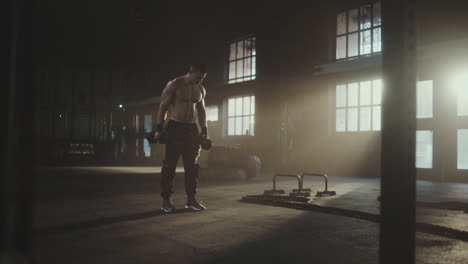 man working out with dumbbells in a gym