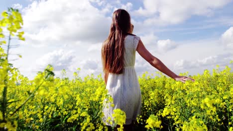 romantic couple holding hands while walking in field