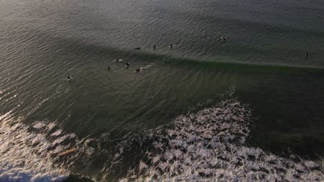 Top-View-Of-The-Surfers-Riding-The-Ocean-Waves-At-Sunshine-Coast-In-Noosa-National-Park-In-Queensland,-Australia