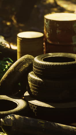 stacked tires and rusty drums