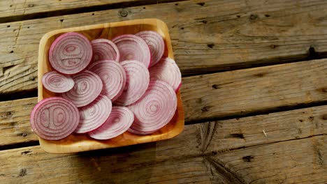 sliced onions in wooden bowl 4k