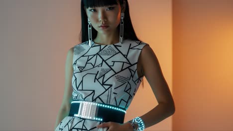 elegant fashion shoot featuring a model in a graphically designed dress with led accents and chic accessories in a stylish indoor setting