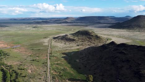 Aerial-drone-shot-panning-360-degrees-revealing-the-vast-lush-fertile-green-farmlands-of-the-Karoo,-Western-Cape,-South-Africa